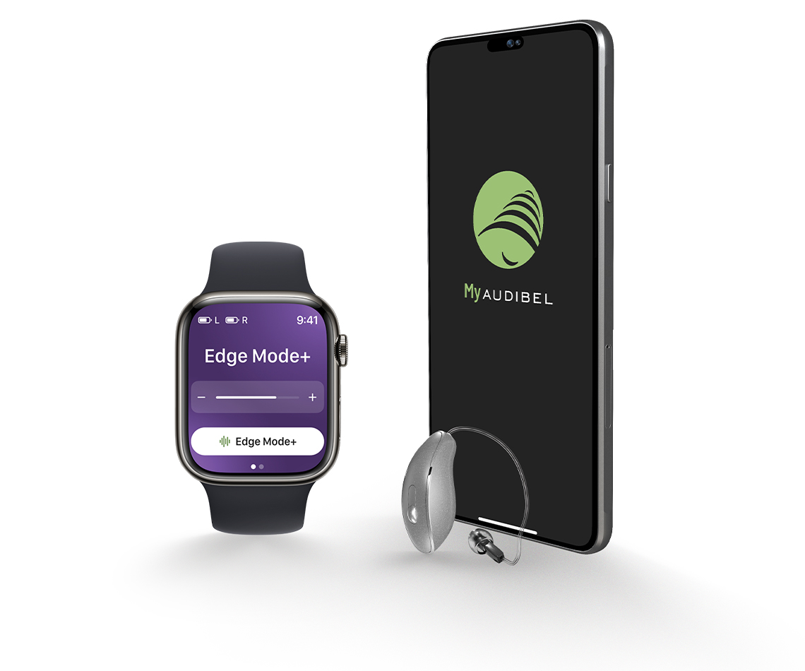 iPhone and Apple watch with the My Audibel app on screen next to a RIC hearing aid.