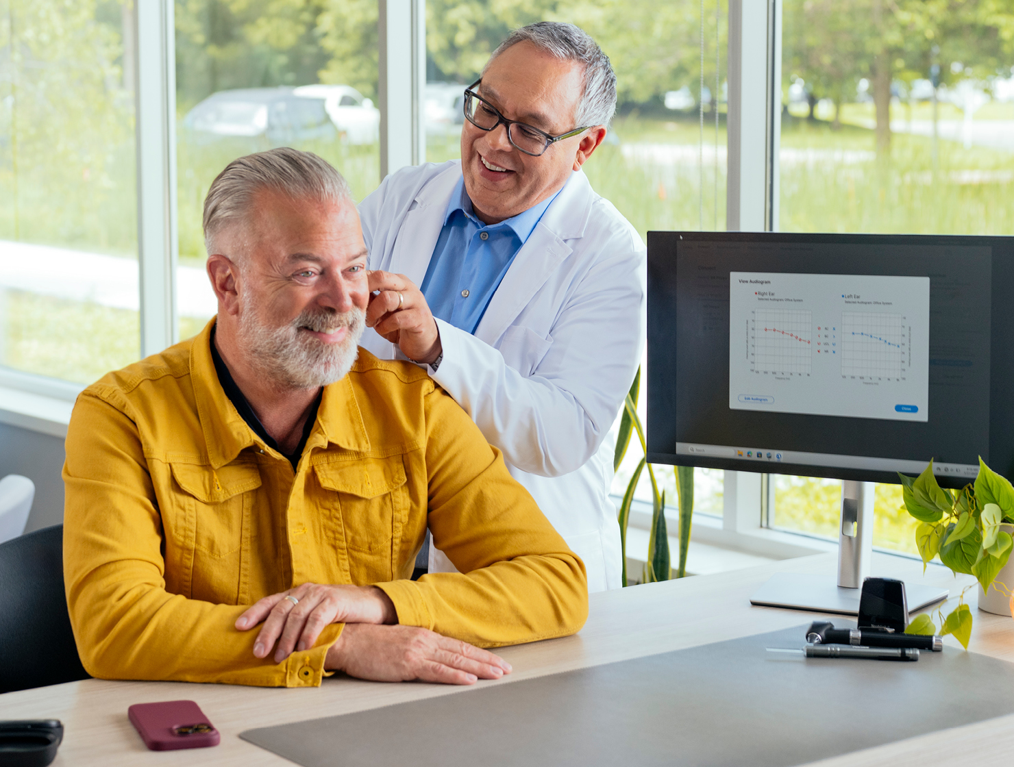 Man being fit with hearing aids.