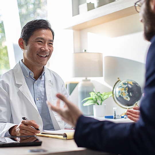 Audiologist meeting with a patient.