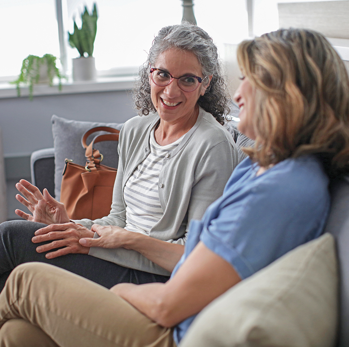 2 ladies sitting on couch